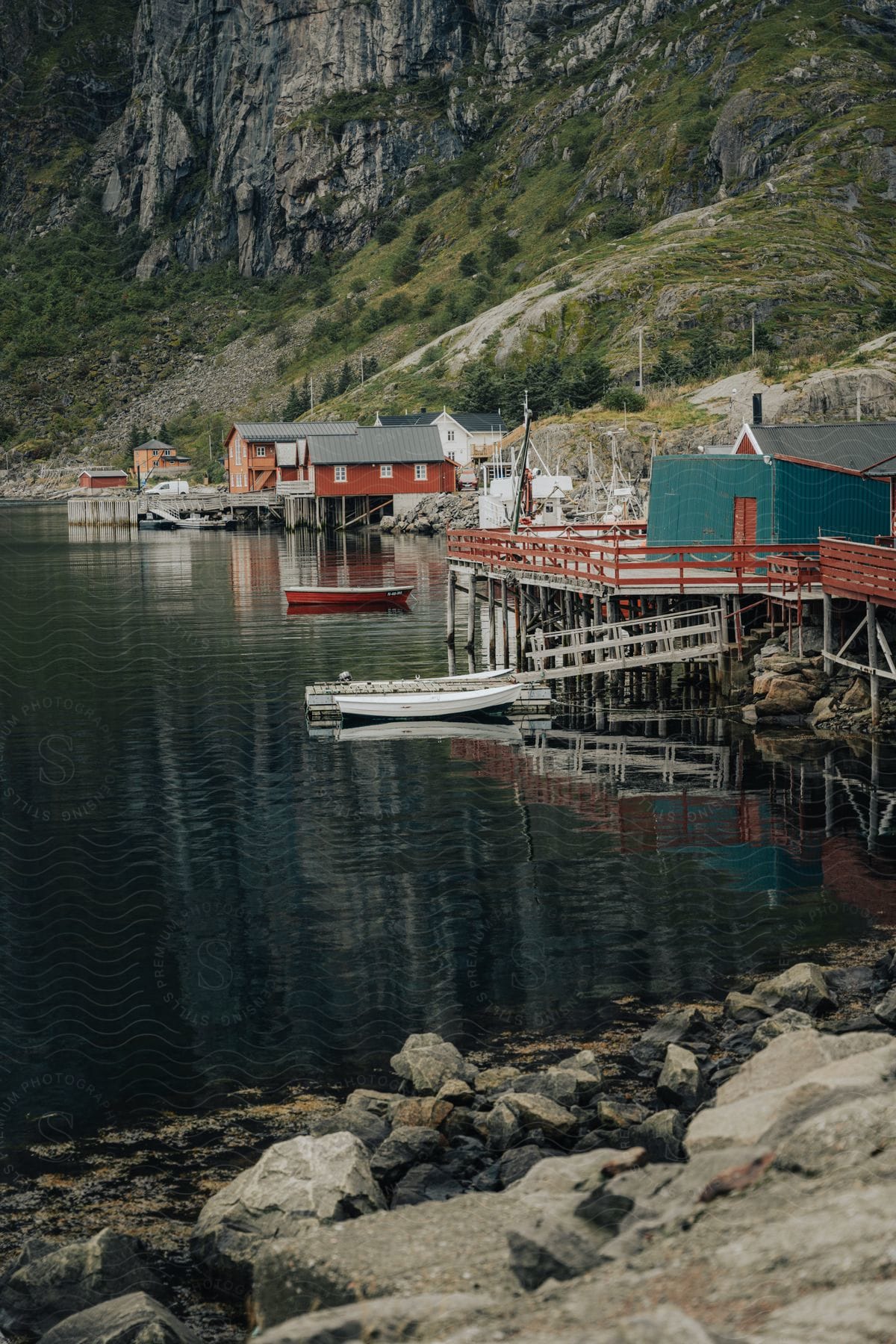 A small coastal town with wooden houses on the seafront.