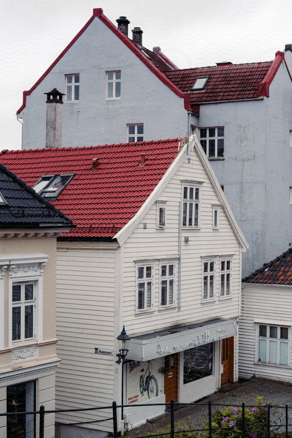 Historic shops in a small town with white walls and red tile roofs.