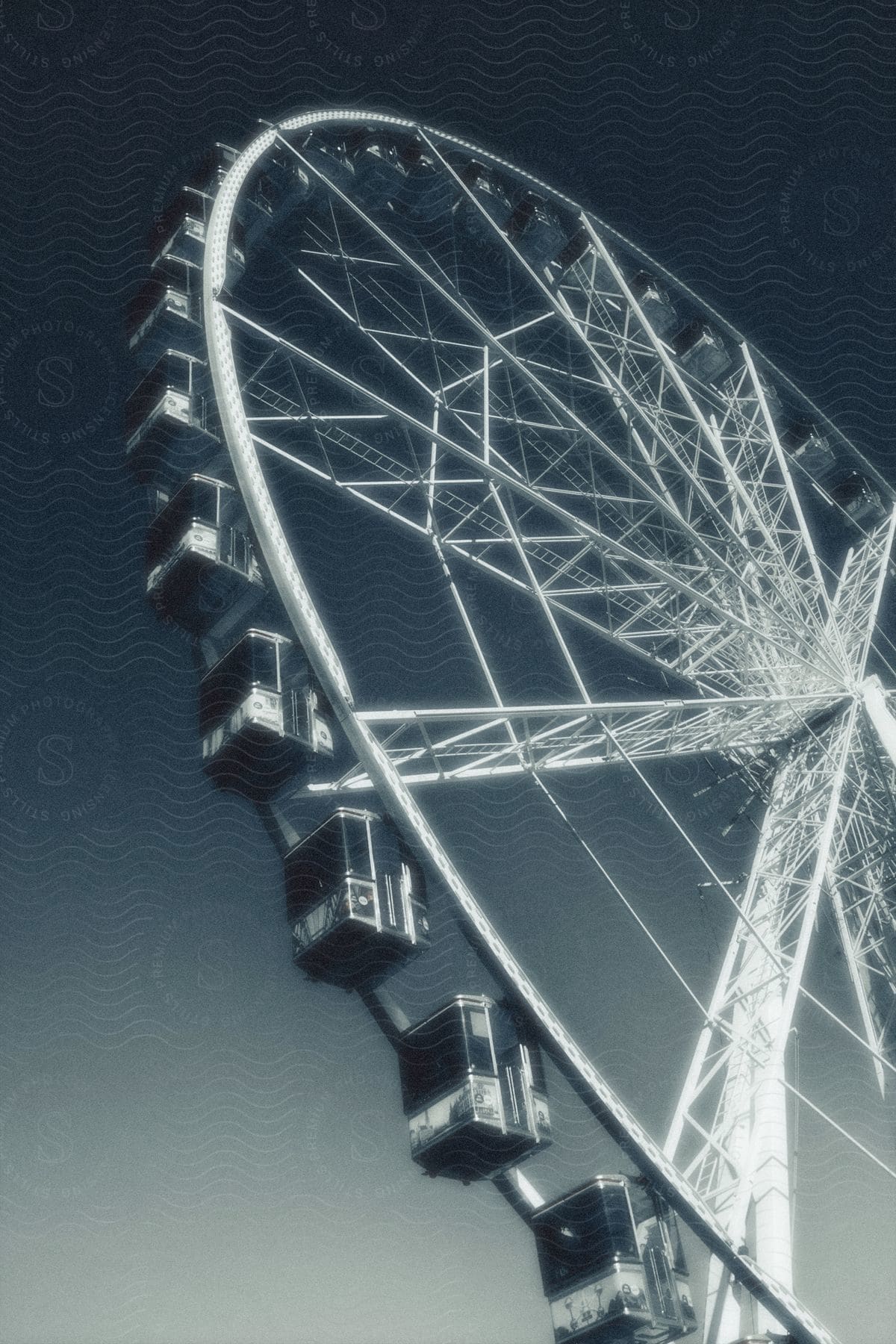 A timeless Ferris wheel against a cloudless sky, captured in black and white.