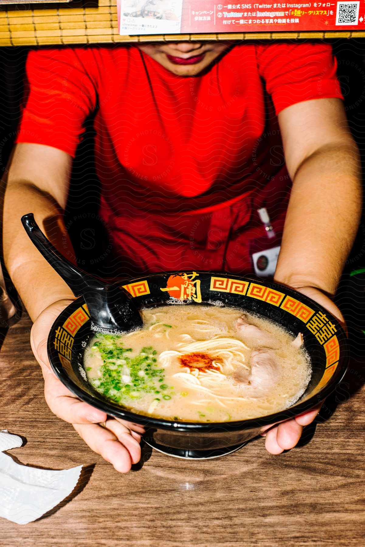 A woman serving a Japanese ramen.