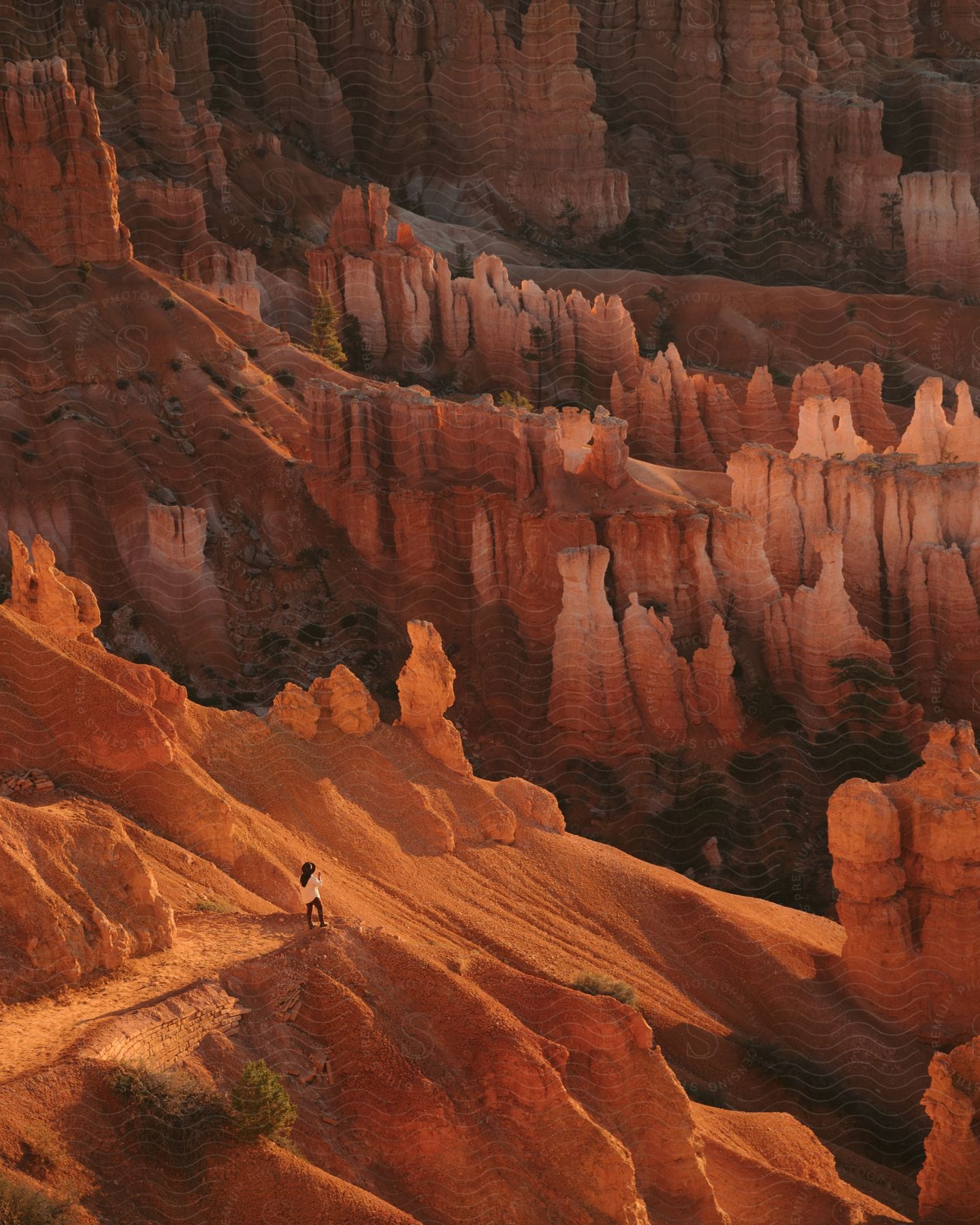A woman walks among rock formations in the red rock canyons