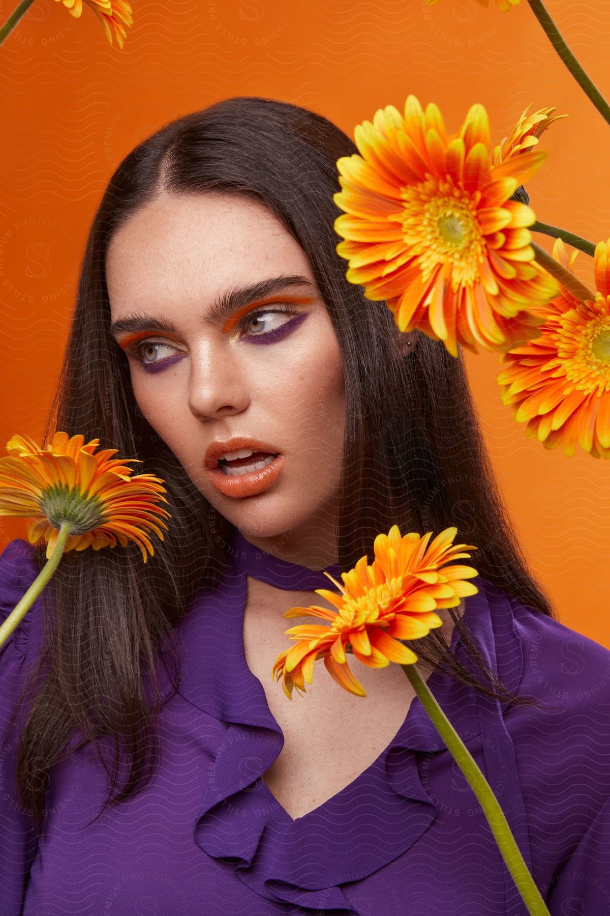 Flowers decorate close up of fashion model.