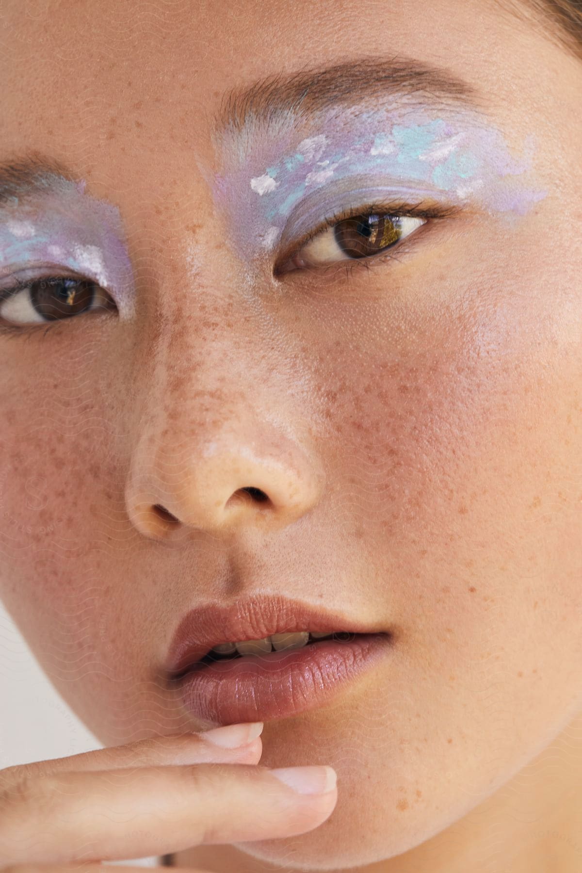 Stock photo of a young girl with light makeup on her eyelids.