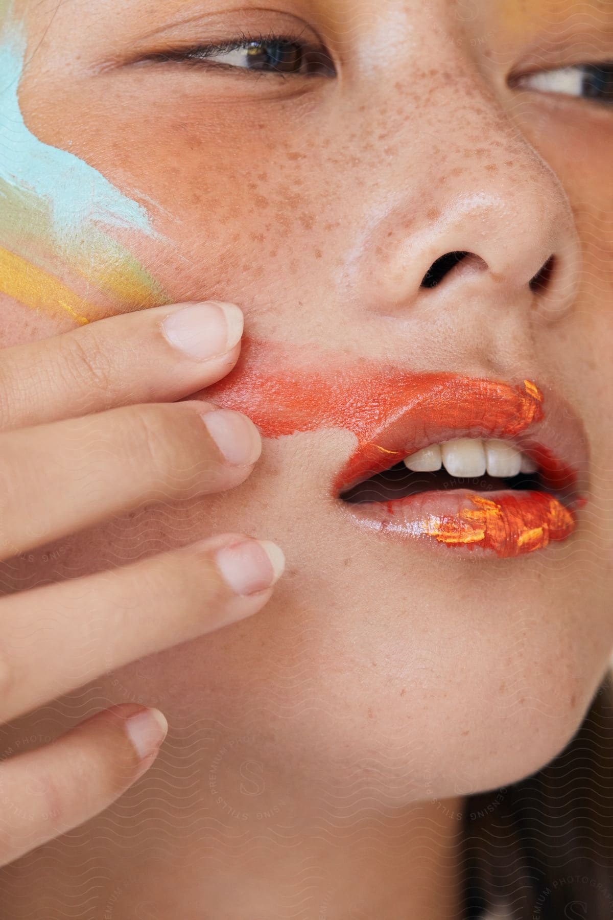 a woman smears her lipstick onto her cheek