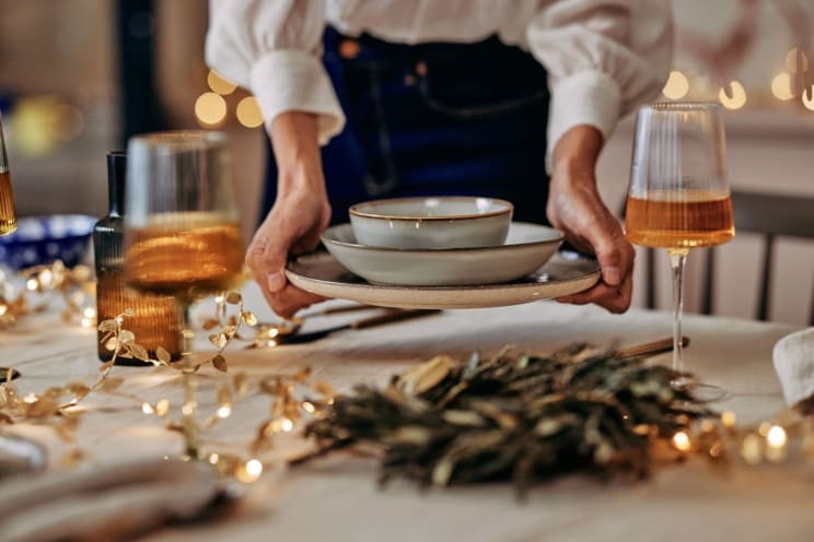 Woman Sets Table During Dinner Party