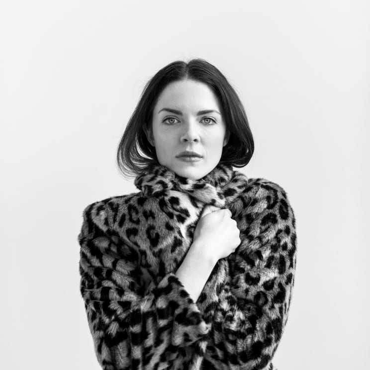 A Woman Holding Her Coat Closed Tight