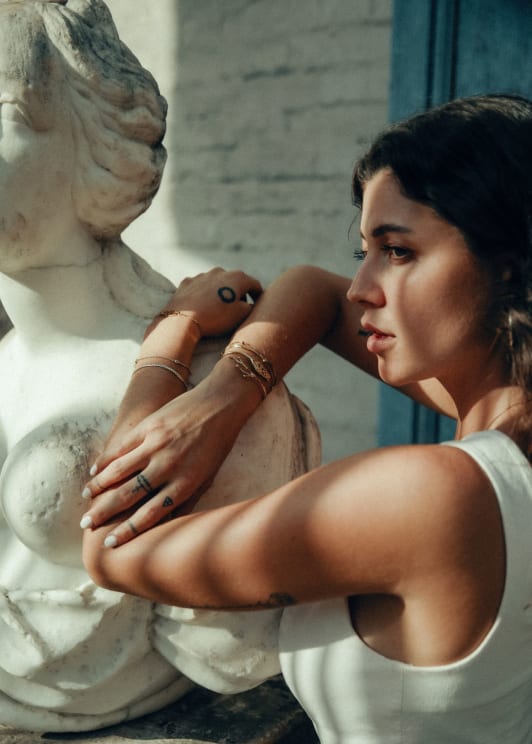 Women Models Jewelry Leaning On Statue