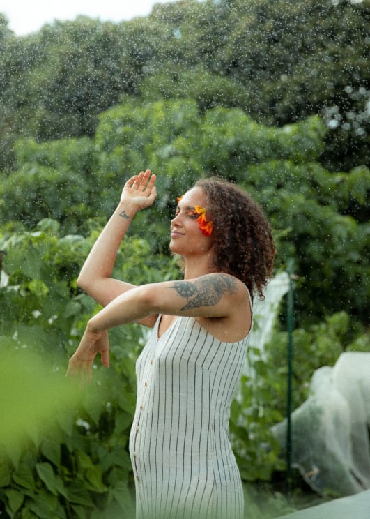 A Tattooed Woman Frolicking In The Rain