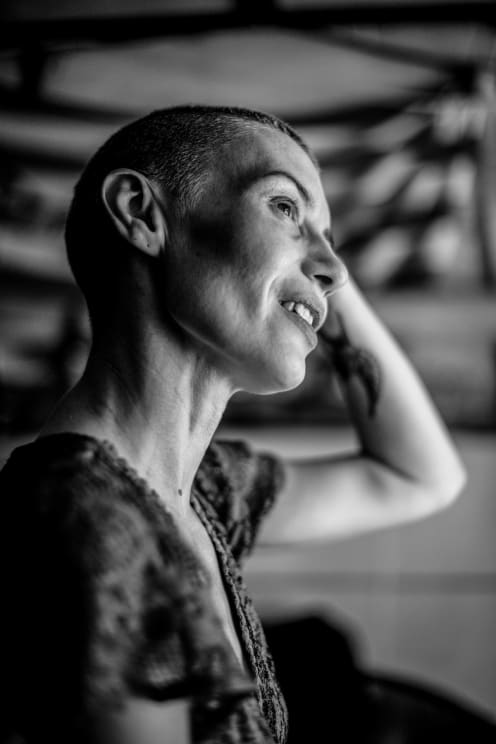 A Woman Tilts Her Head As It Rests On Her Hand