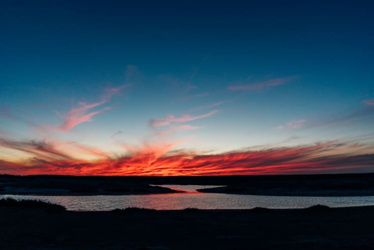 Beach Coasts With Orange Sky During Sunset