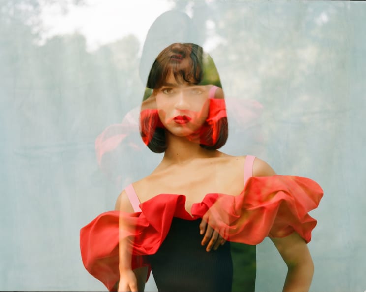 Double Exposure Of An Asian Woman In A Black Dress With Red Ruff And Pink Shoulder Straps