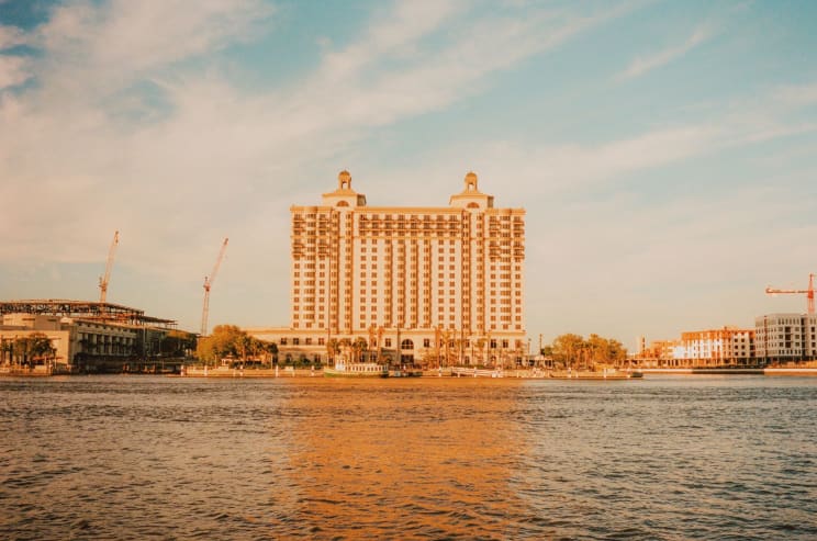 A Tall Hotel With Towers Outdoors On A Sunny Day