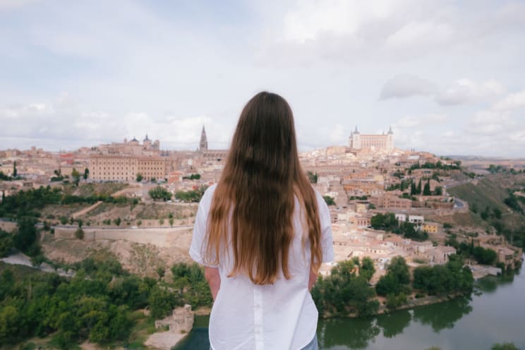 A Woman Looks Out Over An Ancient European City