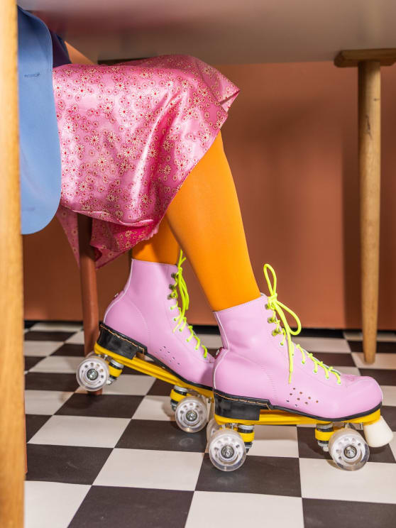 Woman Wearing Bright Colored Clothes With A Pair Of Vintage Roller Skates