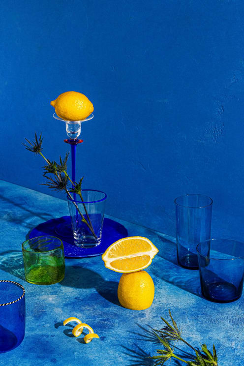 Still Life Of Sicilian Lemons On A Table With Blue Glass Cups