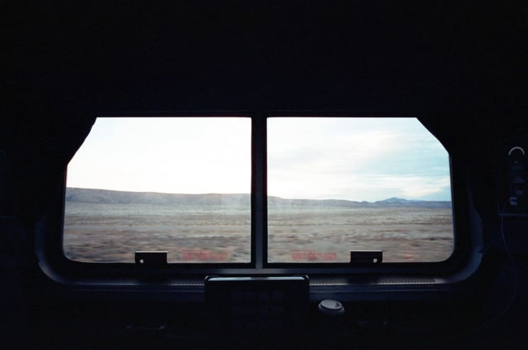 Desert Scenery Seen Through A Train Window, With A Coffee Cup Nearby