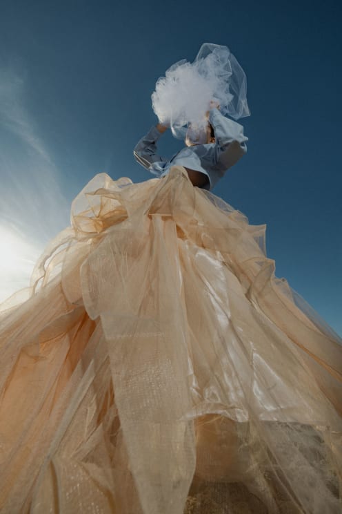 A Woman Modeling A Dress Outdoors On A Sunny Day
