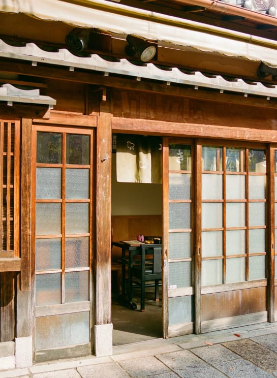 The Exterior Of A Restaurant With The Door Open