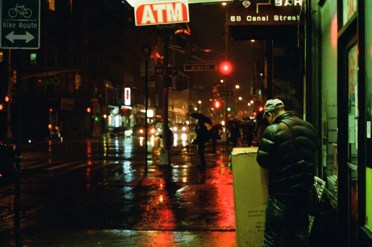 A Lot Of People Walking Around In A City At Night