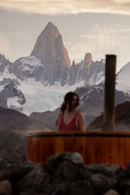 Woman Standing Outside Near A Hot Tub With Mountains In The Distance
