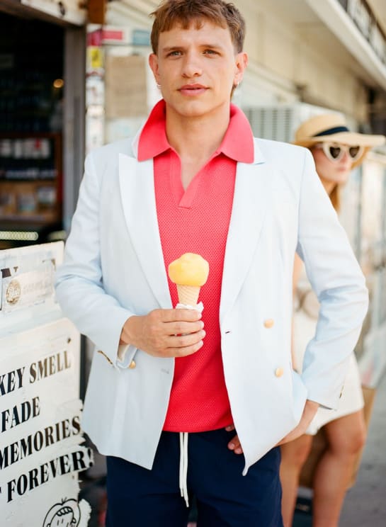 Man In A White Blazer And A Pink Polo Shirt Holding An Ice Cream