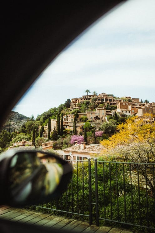 A Group Of Homes And Buildings Atop A Hill
