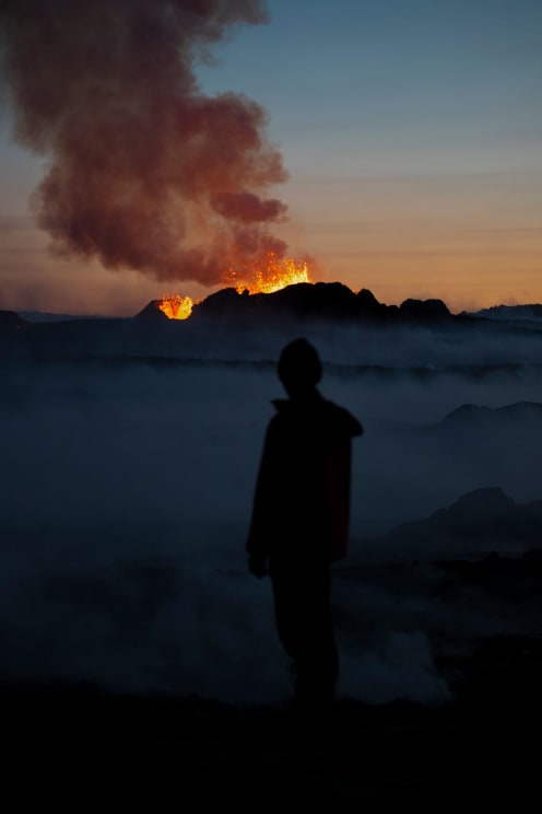 A Person Watching A Volcano Erupt Outdoors