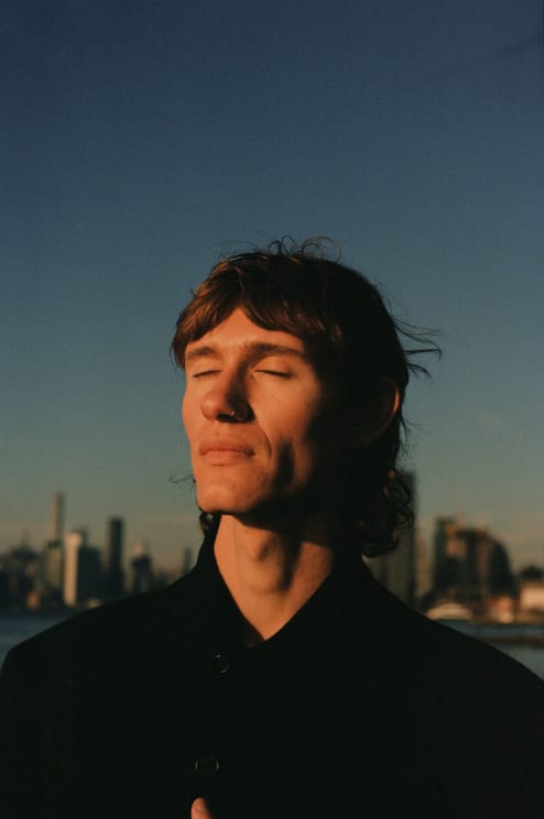 A Portrait Of A Man Standing Outdoors