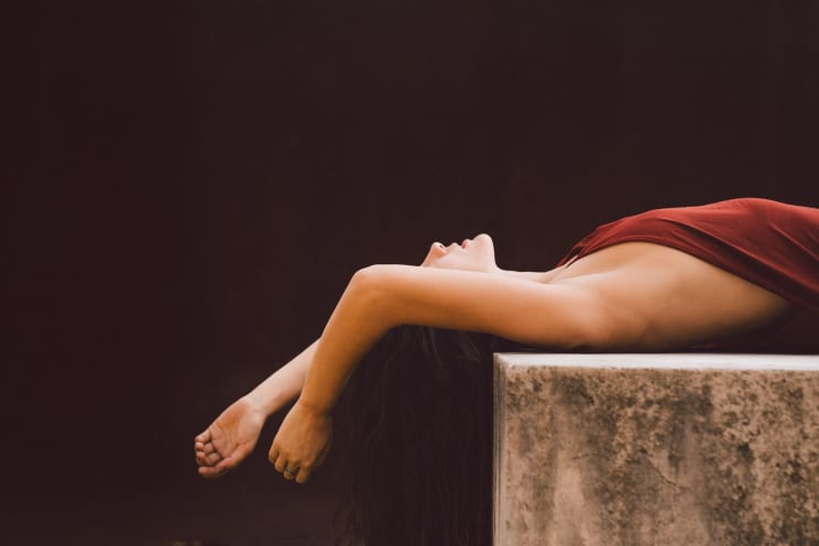 A Woman Laying Around In A Red Dress