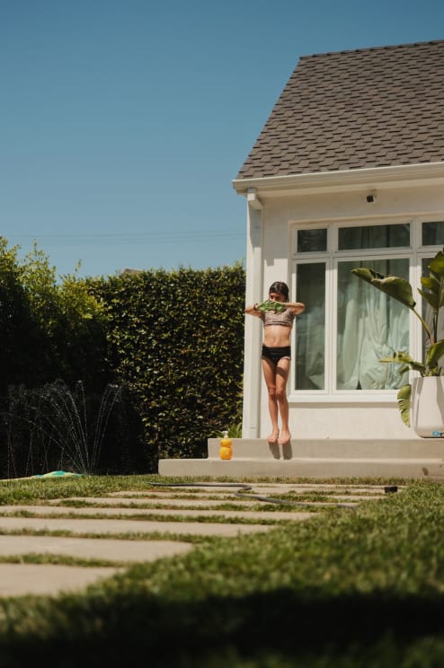 A Girl Playing Outdoors On A Sunny Day