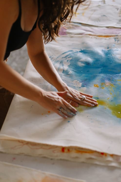Woman Hand Painting On Canvas On The Floor