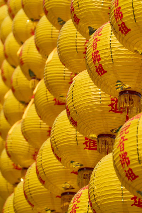 Many Yellow Chinese Lanterns Hang Outdoors Forming A Wall