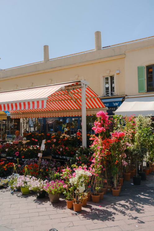 Flowers Being Sold Under An Awning Outside A Building