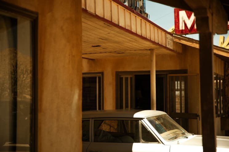 A Car Parked Outdoors At A Motel