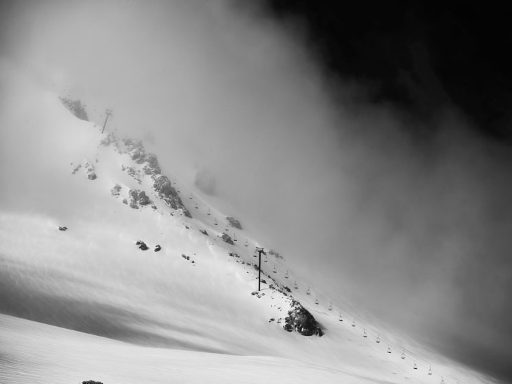 A Ski Lift Descending A Snowy Mountain