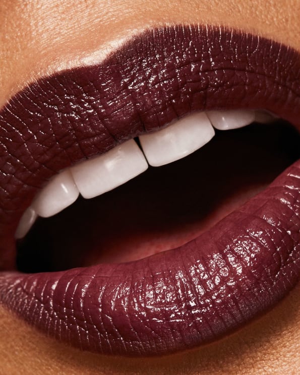 A Woman Opens Her Mouth With Dark Red Lipstick On