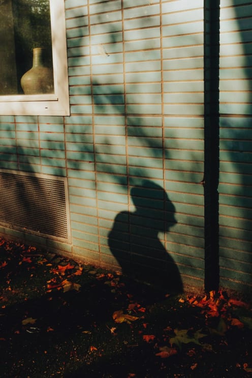 A Shadow Of A Man Walking Outdoors