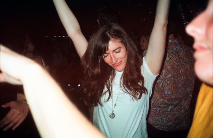 A Young Woman Smiles While Dancing At A Party At Night