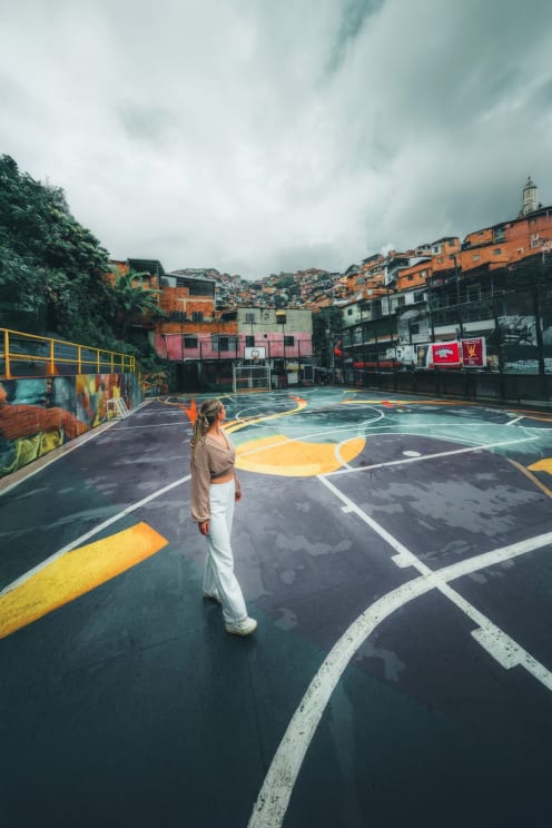 A Woman Stands In A Basketball Court