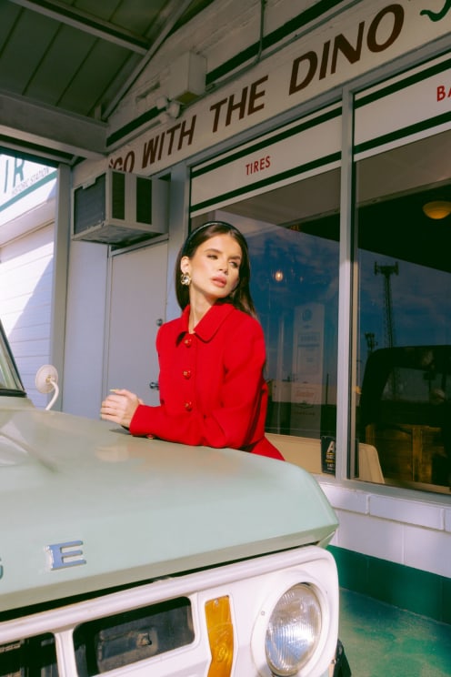 A Woman Leaning On The Hood Of A Truck