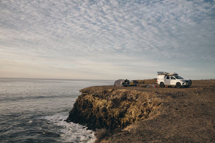 A Man With His Truck On The Coast