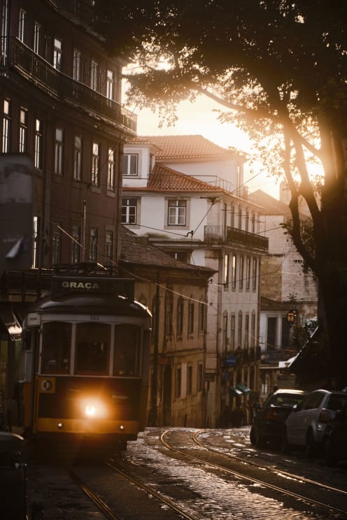 Vintage Tram Passing Through The Streets Of A Classic City At Sunset