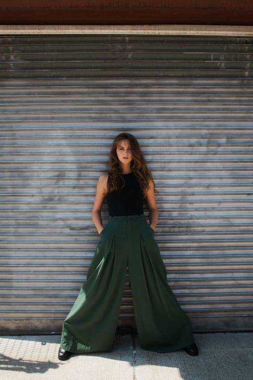 A Woman In Long Parachute Pants Poses
