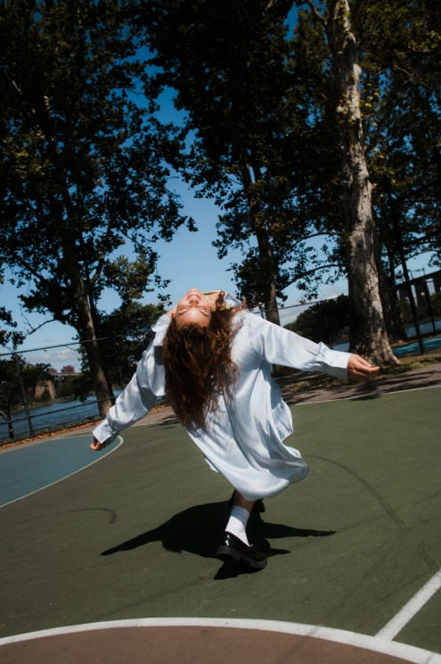 A Woman Dancing On A Courtyard