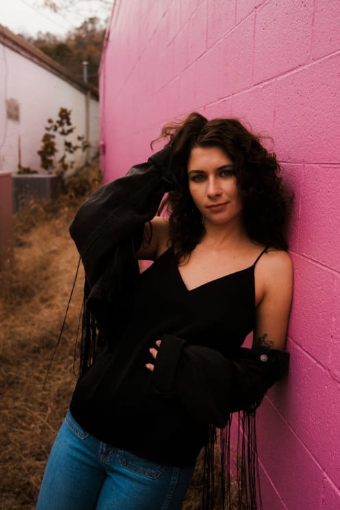 A Woman Leaning On The Wall