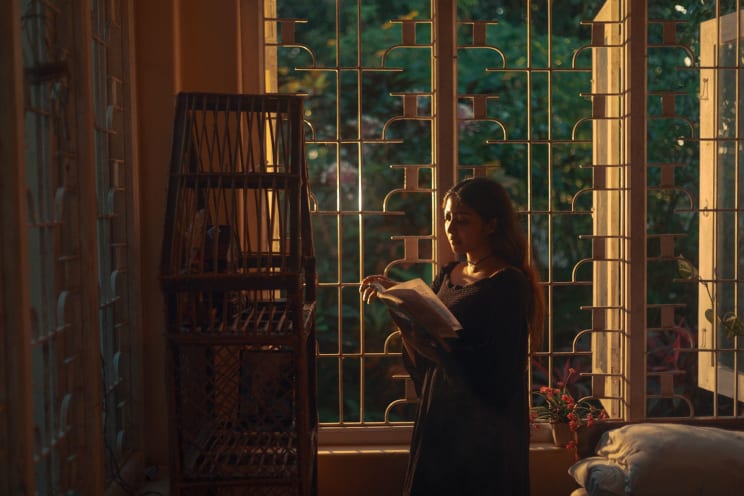 A Woman Holding A Book And Doing Themselves