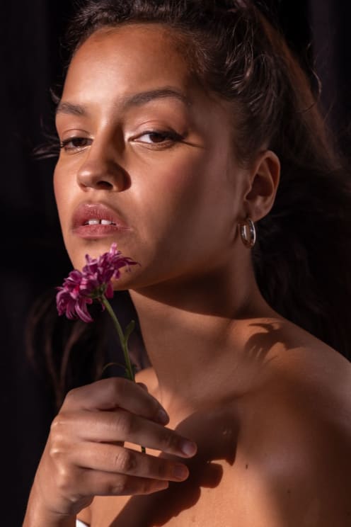A Woman With A Flower In Her Mouth
