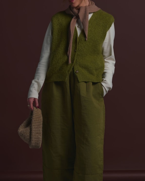 Woman Holding A Knit Hat Wears A Fall Outfit