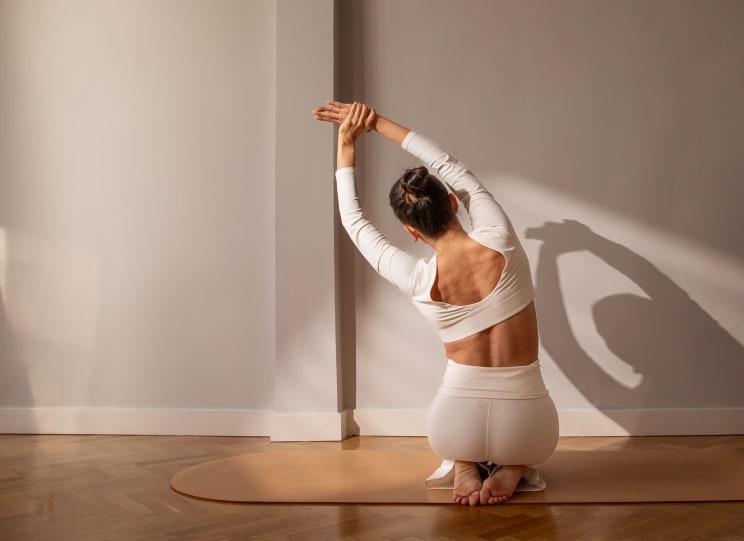 A Woman In White Doing Yoga