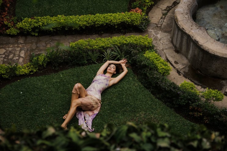 A Woman Modeling A Dress Outdoors